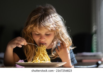 Cute Child Eats Food Itself With Spoon. Cute Little Kid Eating Spaghetti Pasta At Home.