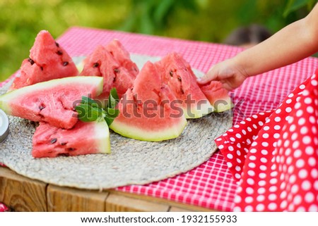 Cute child eats ripe juicy watermelon at summertime. Child, baby, healthy food snack for children.