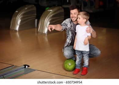 Cute Child With Father In Bowling Club