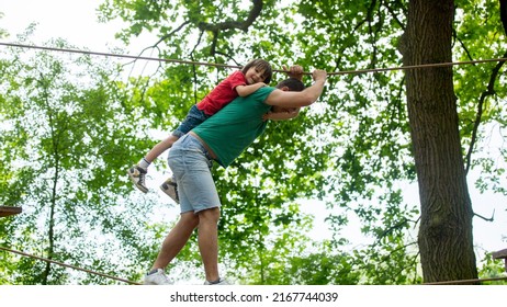 Cute Child And Father, Boy And Dad, Climbing In A Rope Playground Structure, Springtime