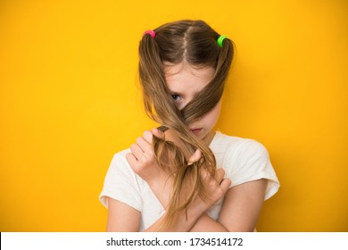 Cute Child Girl Closes Her Face With Her Hair. Menstrual Period For The First Time Concept