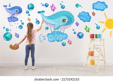 Cute child girl drawing colorful dye white wall in room