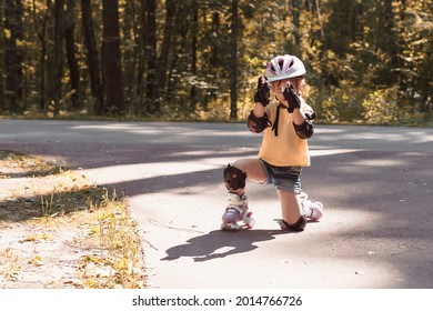 Cute Child Girl In Protective Sportswear Rollerblading.