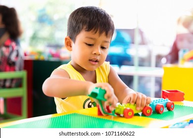 A cute child playing with color toy indoor