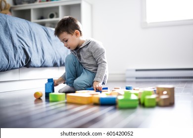 A cute child playing with color toy indoor