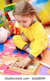 Cute child playing with puzzle
