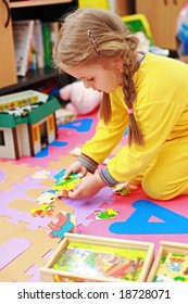 Cute child playing with puzzle