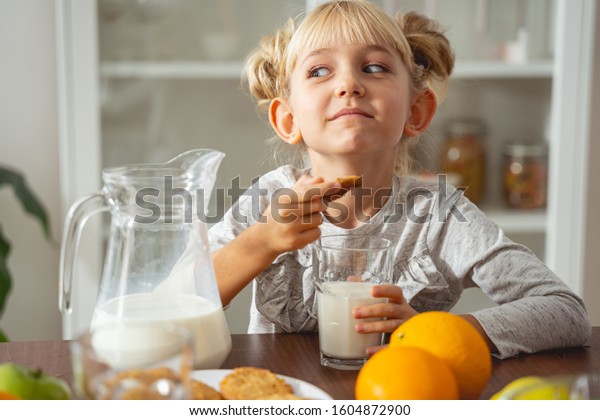 child sitting at kitchen table