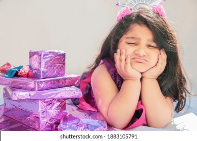 Cute Child Unhappy With Bad Birthday Present. Portrait Of Sad Little Girl With Gift Box.