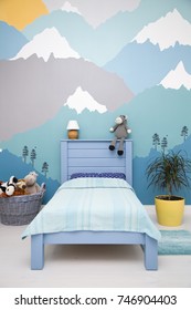 Cute children bedroom design with a blue turquoise grey mountain wall mural - Shutterstock ID 746904403