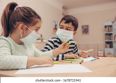 Cute children boy and girl in medical mask is sitting at home in quarantine. Entertainment for the children during quarantine - drawing. Self isolation.       