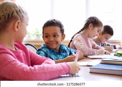 Cute children doing homework in classroom at school - Shutterstock ID 1175286577