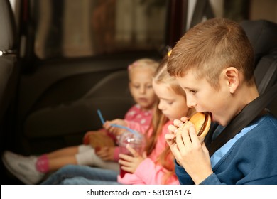 Cute Children Eating In A Car