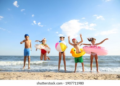 Cute Children Enjoying Sunny Day At Beach. Summer Camp