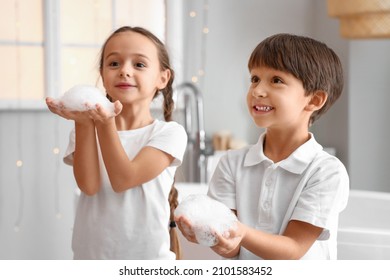 Cute Children Playing With Soap Foam In Bathroom