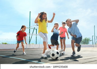 Cute Children Playing Soccer Outdoors On Sunny Day. Summer Camp