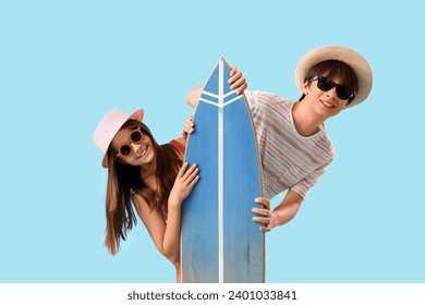 Cute children with surfboard on blue background - Powered by Shutterstock