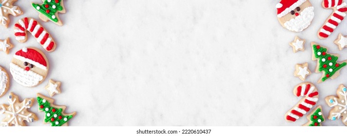 Cute Christmas cookie double border. Above view on a white marble banner background with copy space. Holiday baking concept. Santa Claus, tree, snowflakes, candy canes, stars. - Powered by Shutterstock