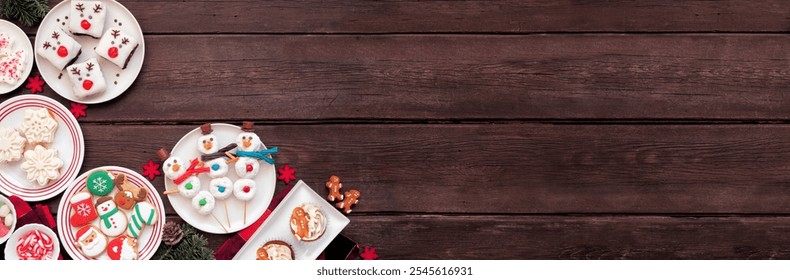 Cute Christmas desserts corner border. Overhead view on a dark wood banner background with copy space. Fun holiday baking concept. Cookies, brownies, donuts, cupcakes and sweets. - Powered by Shutterstock