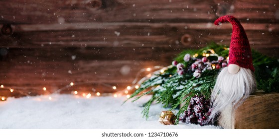 Cute christmas gnome is sitting and waiting for his presents for christmas - banner, header, headline format - Shutterstock ID 1234710676