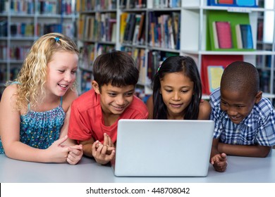 Cute Classmates Looking At Laptop In Classroom