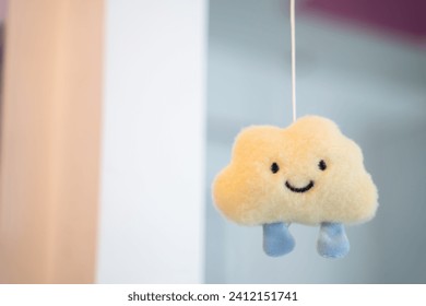 A cute cloud mobile with a smiley face hangs to decorate the interior of a cafe. - Powered by Shutterstock