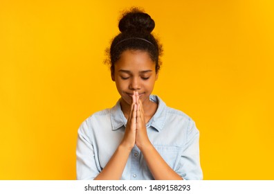 Cute Concentrated African American Girl Praying With Hands Clasped Near Face, Free Space