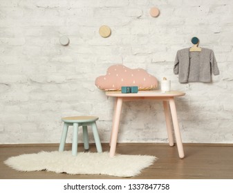 Cute Corner In The Nursery Room, Wooden Kids Furniture Against The White Brick Walls