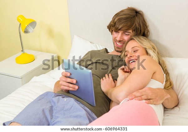 Cute Couple Cuddling Using Tablet Bedroom Stock Photo Edit