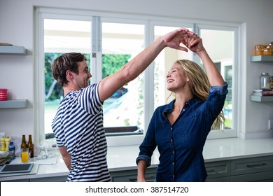 Cute Couple Dancing In The Kitchen