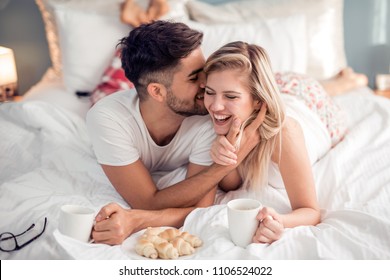 Cute Couple Having Breakfast  And Drink Coffee In Bed In The Bedroom