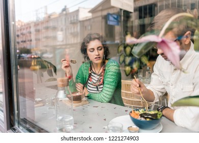 Cute couple. Cute loving couple feeling rested while having breakfast together in cozy vegan cafeteria - Shutterstock ID 1221274903