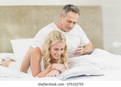 Cute Couple Reading The News In Their Room