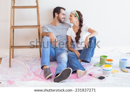 Cute couple redecorating living room in their new home [[stock_photo]] © 