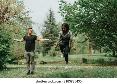 Cute couple rope jumping in the park on the grass