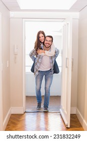 Cute Couple Walking Through The Door In Their New Home