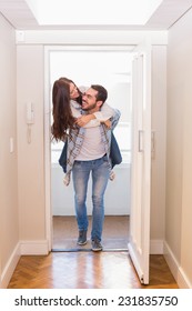 Cute Couple Walking Through The Door In Their New Home