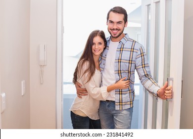 Cute Couple Walking Through The Door In Their New Home