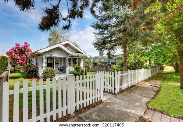 Cute craftsman home exterior with picket fence.\
Northwest, USA