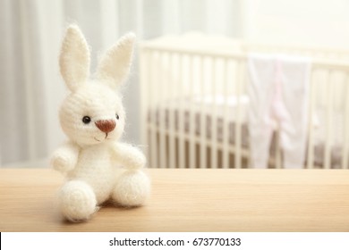 Cute Crochet Bunny Baby Toy On Table In Bedroom