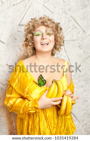 cute curly plus size caucasian woman with fresh yellow banana so happy