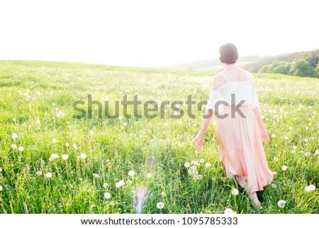 Cute dandelion woman in summer dress