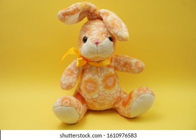 cute easter bunny rabbit plush doll Sitting on yellow background