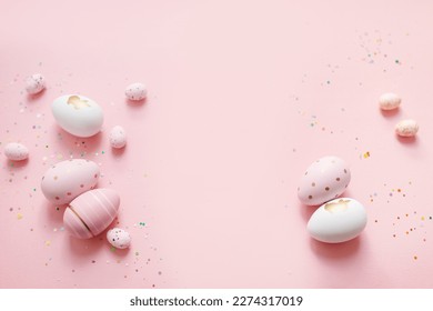 cute easter composition. painted eggs, confetti  on a pastel pink background. top view. copy space. flat lay. place for text