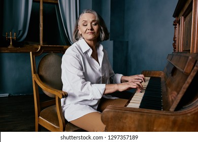 Cute elderly woman playing the piano - Powered by Shutterstock