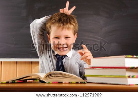 Cute elementary aged boy fooling at the lesson