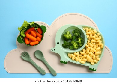 Cute elephant-themed baby feeding set with healthy food on blue background. - Powered by Shutterstock