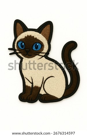 A cute, embroidered patch of a Siamese cat. The design features a cream-colored body, dark brown points on its face, ears, paws, and tail, and striking blue eyes.