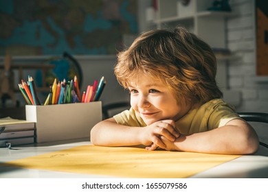 Cute Face Of Pupil, Close Up. Pupil Learning Letters And Numbers. Children Learning. Cute Child Boy In Classroom Near Blackboard Desk