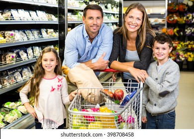 Cute Family Doing Grocery Shopping Together At The Supermarket